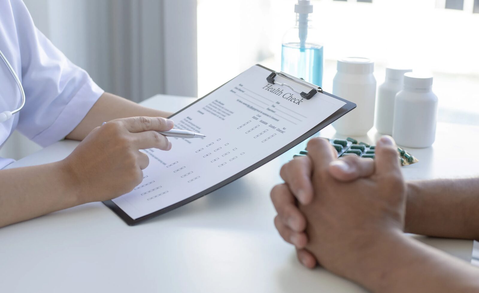 A health review being recorded on a clipboard during a consultation